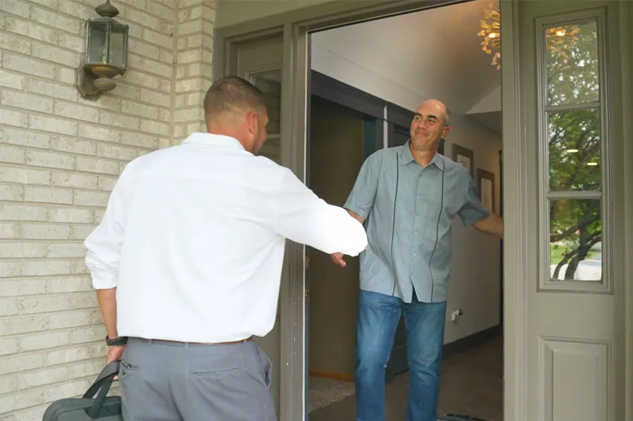 A King technician greeted at the front door by a homeowner