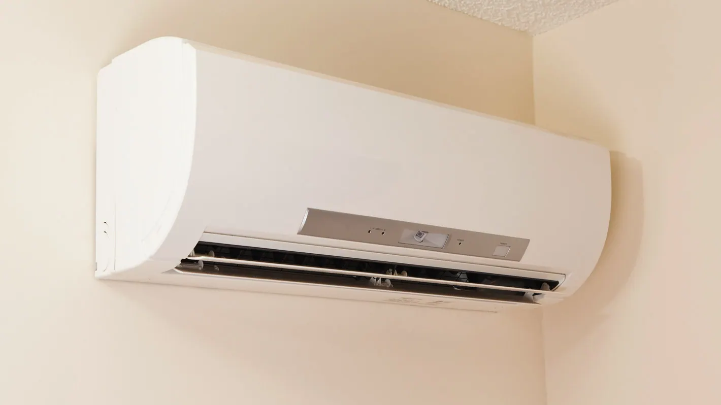 A ductless mini-split indoor unit mounted high on a wall