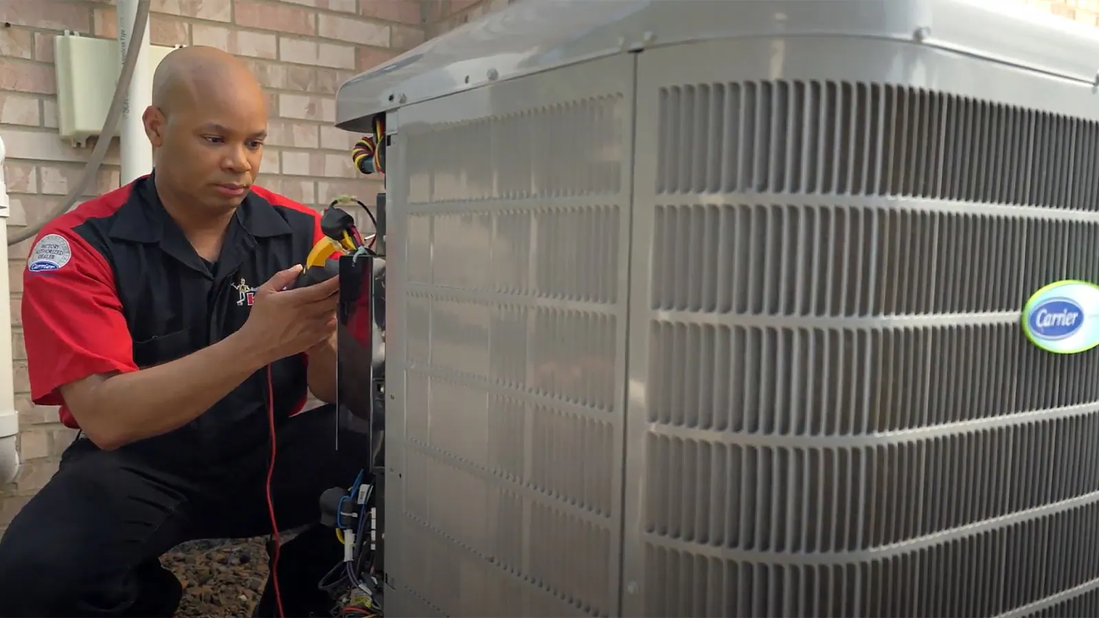 A King technician servicing an outdoor AC unit