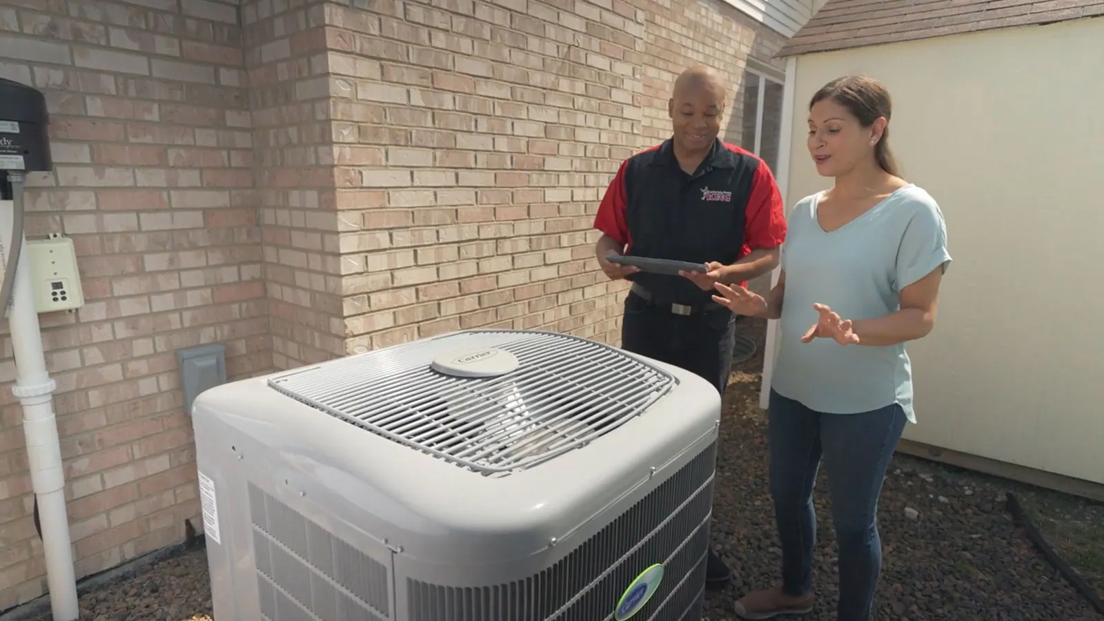 A King technician doing an AC tune-up for an Oak Forest homeowner