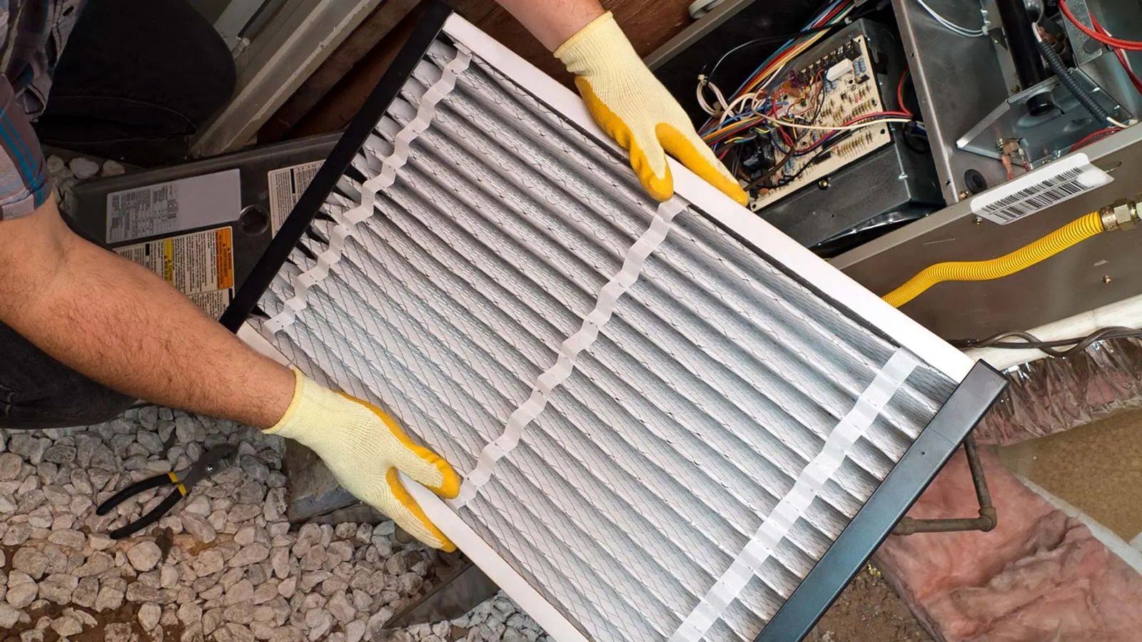 Hands holding a new furnace filter