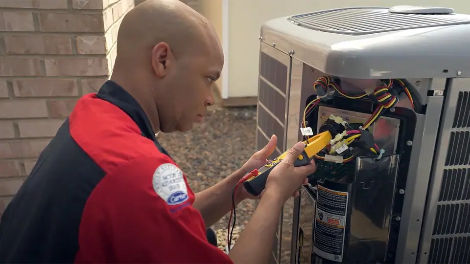 King Heating technician diagnosing an AC repair in the Chicago area