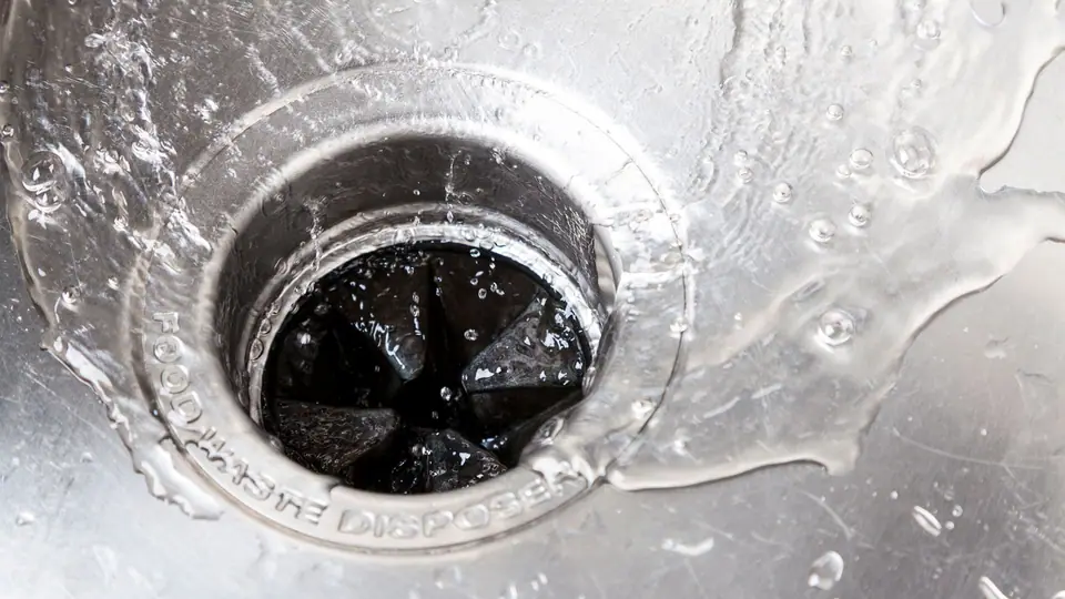 Kitchen sink and garbage disposal in a Chicago-area home, where grease and food waste are a common cause of drain and sewer clogs