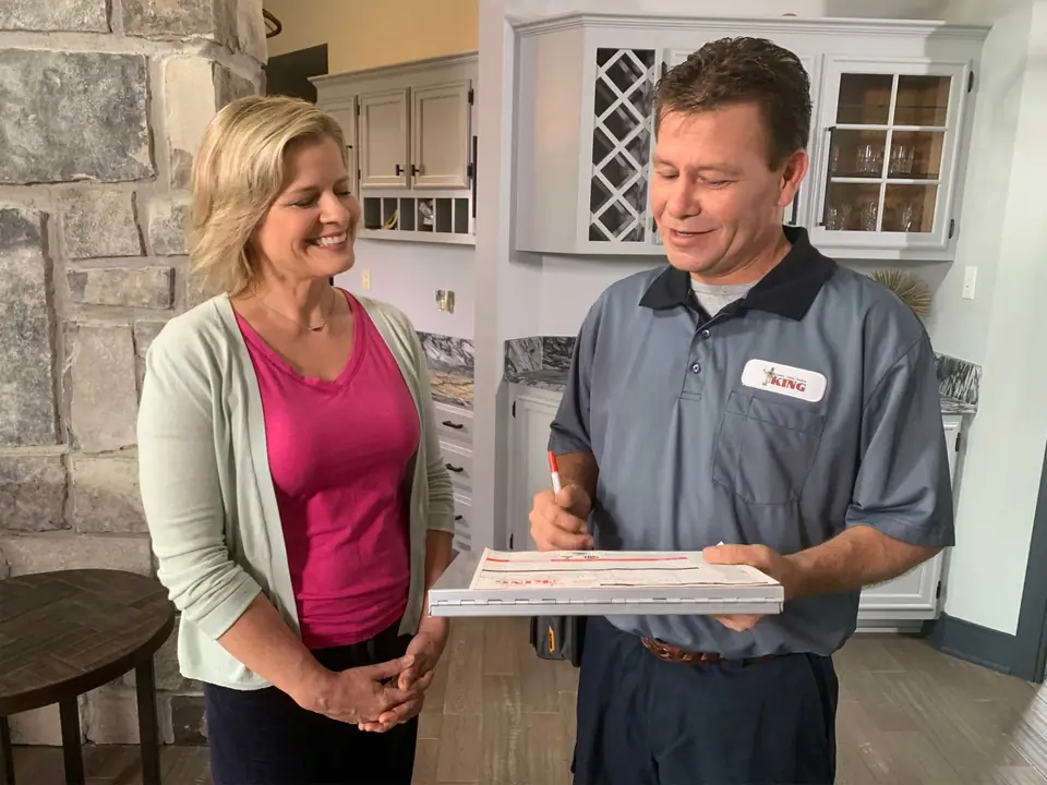 King plumber with happy homeowner
