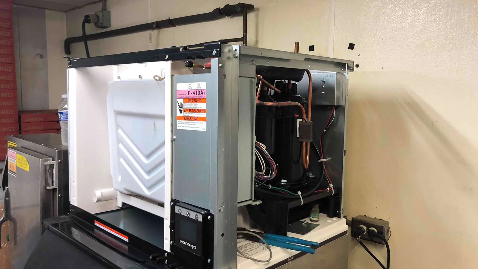 A commercial condensing unit with its service panel open