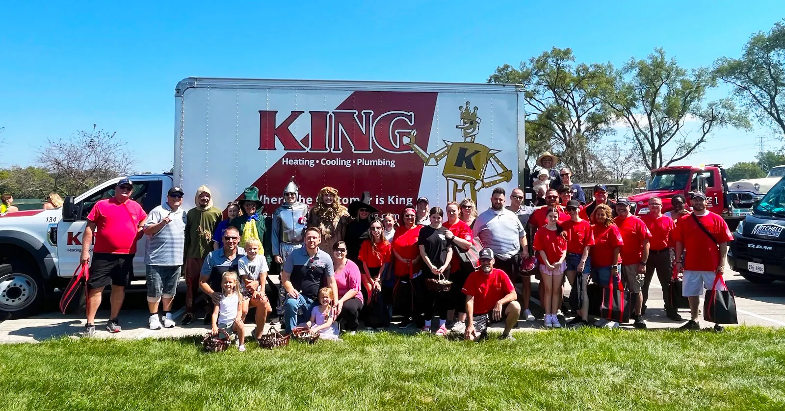King team members and their families gathered in front of a King truck