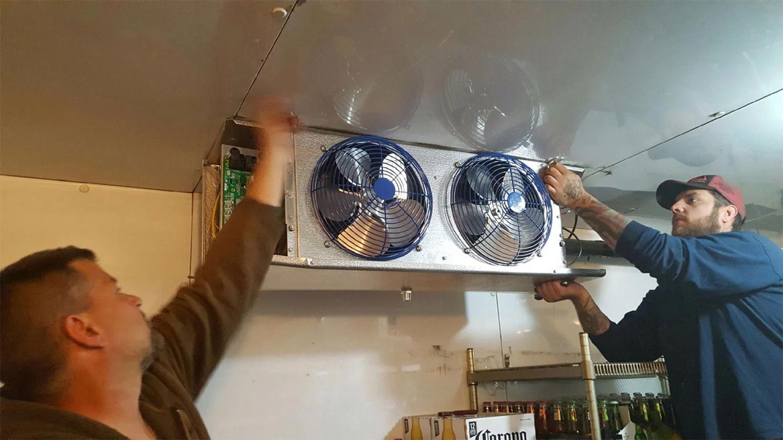 King technicians installing a walk-in cooler evaporator