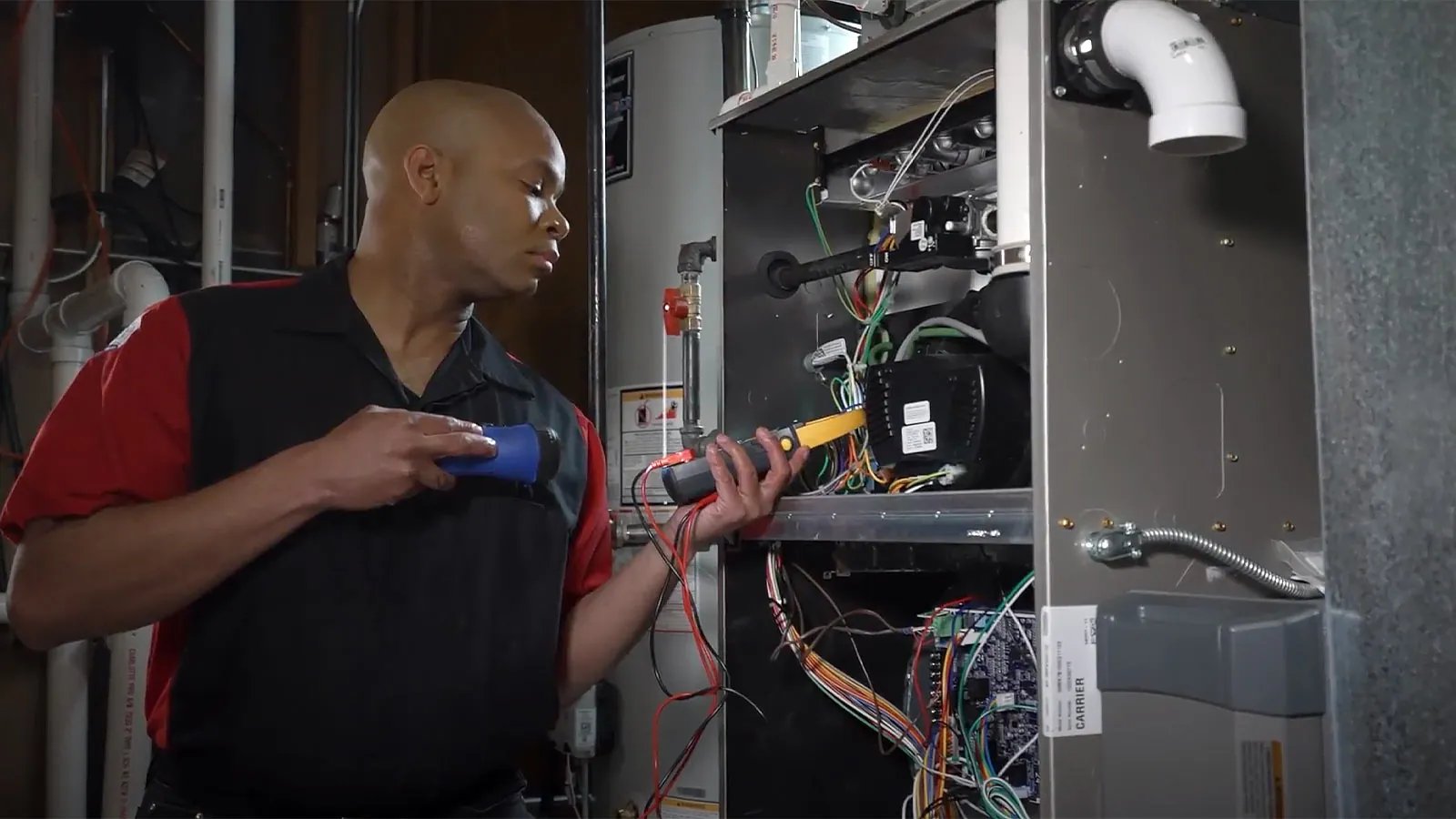 A King technician testing an open furnace with a multimeter