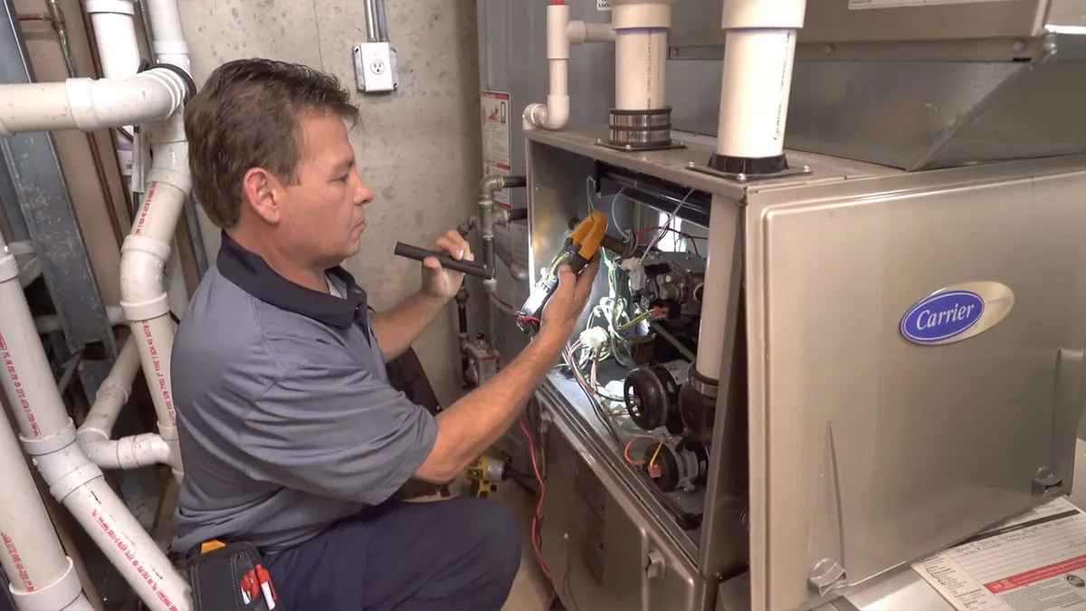 A King technician checking a new Carrier furnace