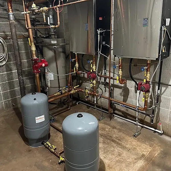 A new boiler with copper piping in a basement