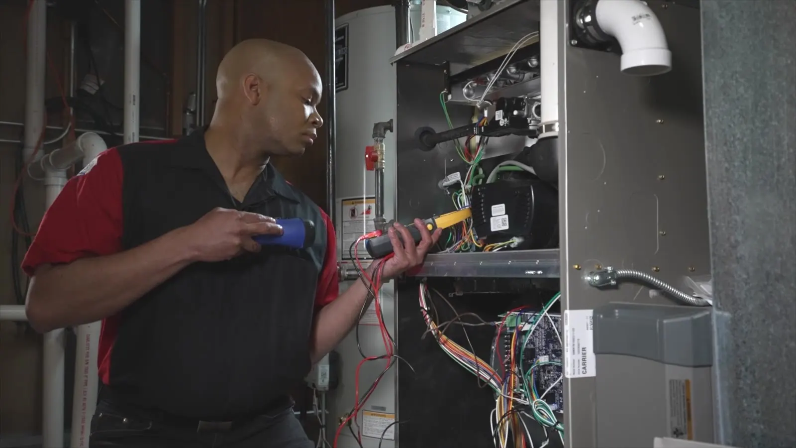 A King technician testing the controls of a Carrier furnace