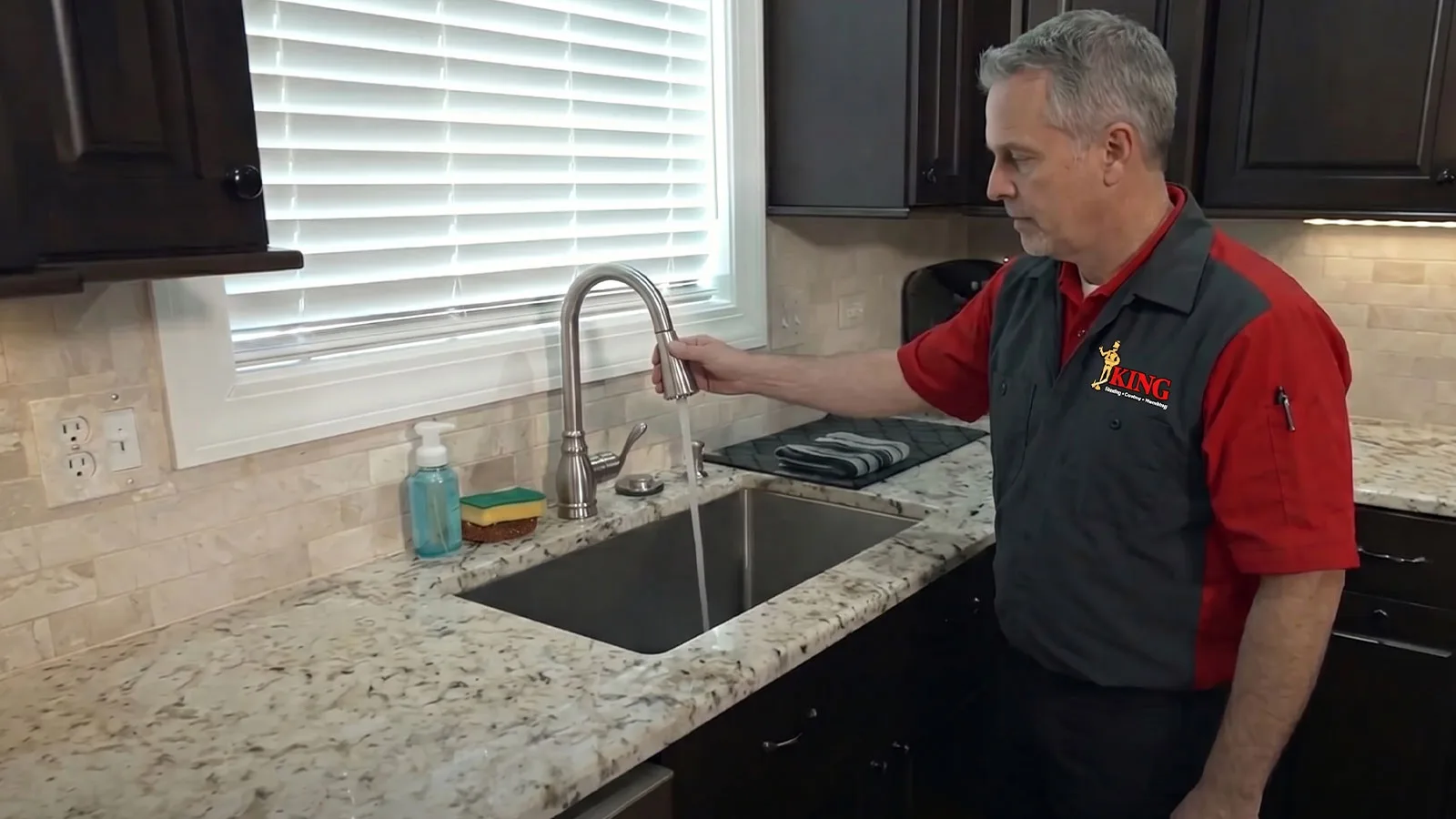 A King plumber checking a faucet