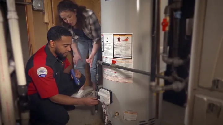 A King plumber repairing a tank water heater