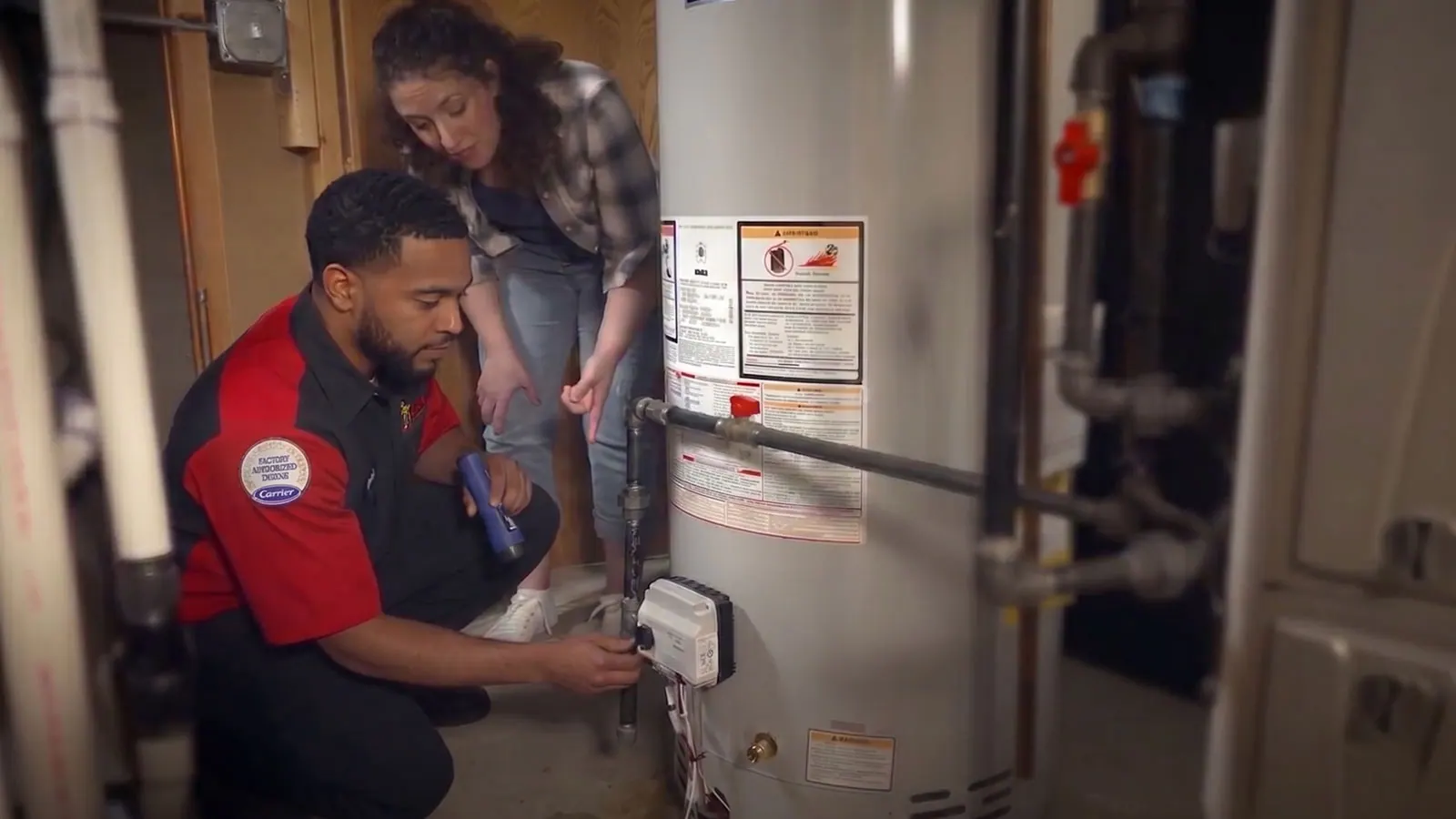 A King plumber working on a tank water heater