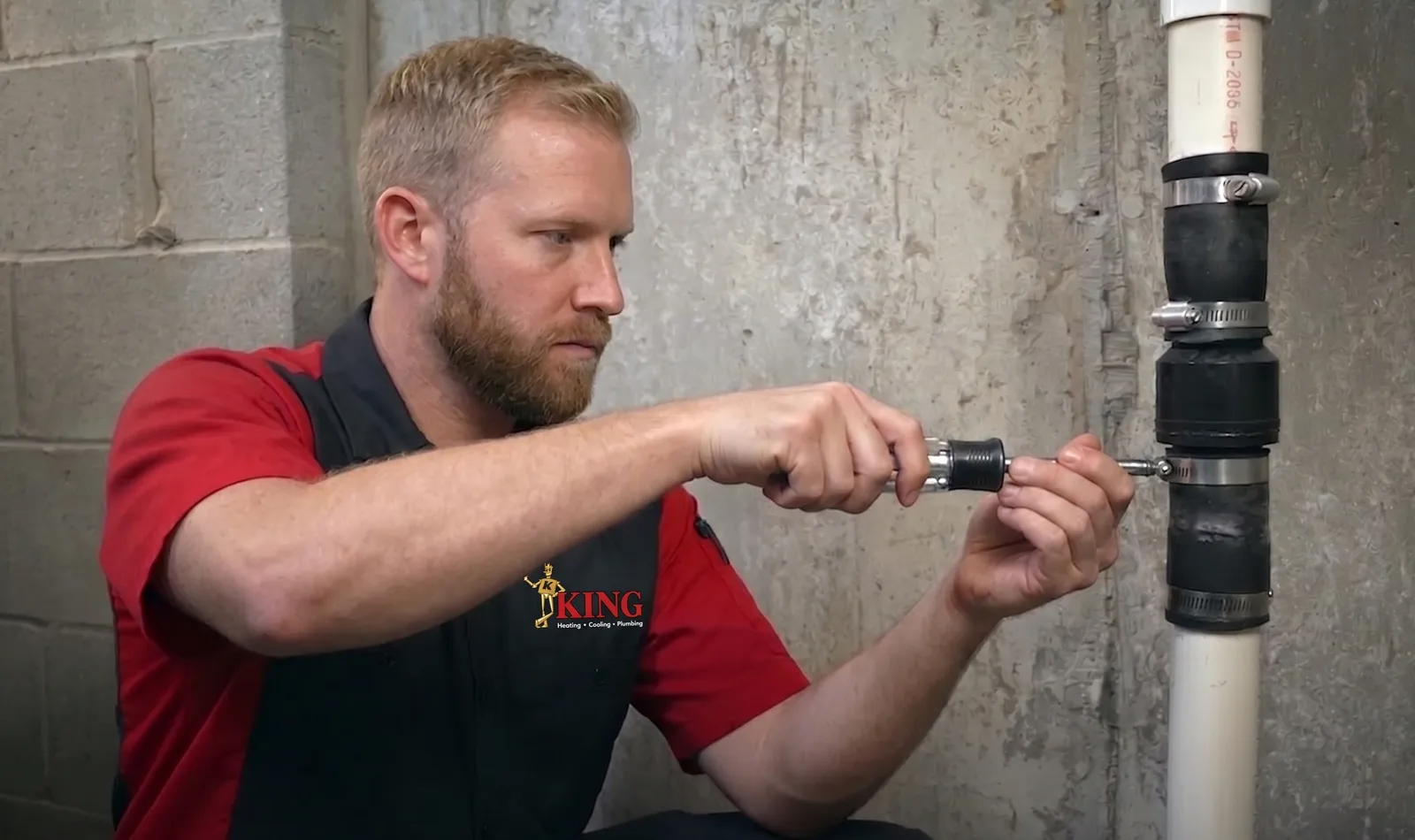 A King plumber replacing a basement sump pump