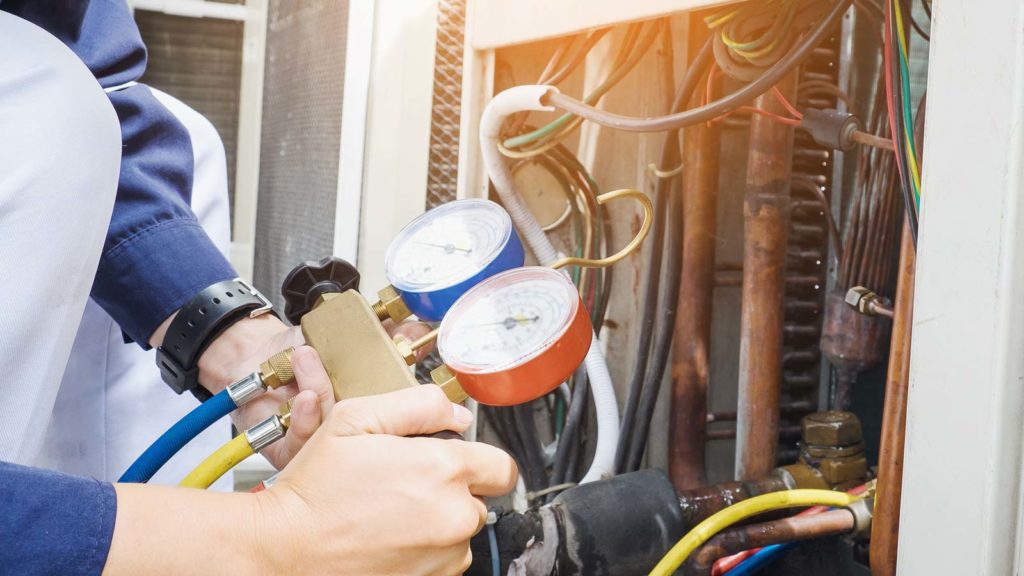 Our tech checks the refrigerant levels of an air conditioning unit in Northwest Indiana, making sure it's ready for summer.