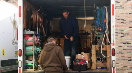 As part of a furnace tune-up call from a local customer, one of our technicians carries all their gear into a local home.