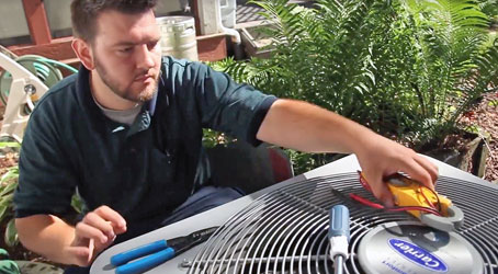 Using specialized equipment, a King technician performs seasonal maintenance on a local AC unit here in Chicago, IL