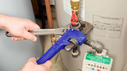 A King plumber uses a wrench to make adjustments and maintain a local home's water heater here in Chicago.
